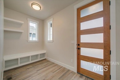 Mudroom with light wood-type flooring and baseboards