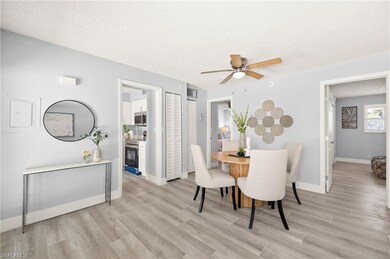 Dining area with light wood-type flooring, ceiling fan, a textured ceiling, and baseboards