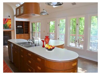 Kitchen wall with fireplace divides the kitchen fr