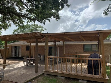Backyard with pergola and paved stoned patio