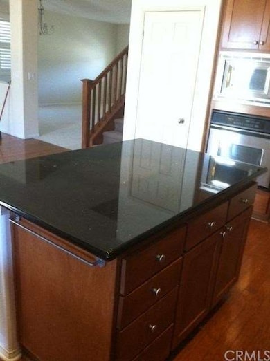 Island at kitchen with granite counter top.  