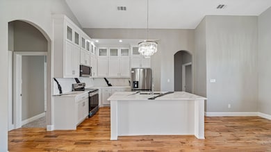 Kitchen featuring stainless steel appliances, arch