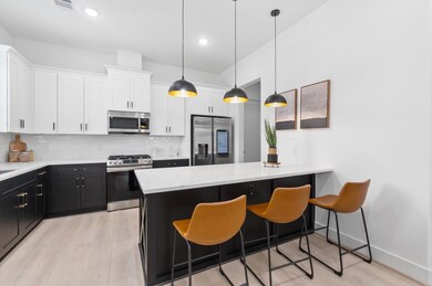 Oversized peninsula with pendant lights.
