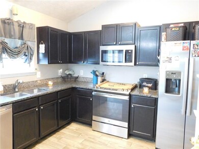 Kitchen featuring stainless steel appliances, a si