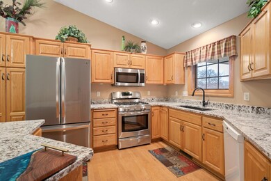 Kitchen with new appliances and stone counter tops.
