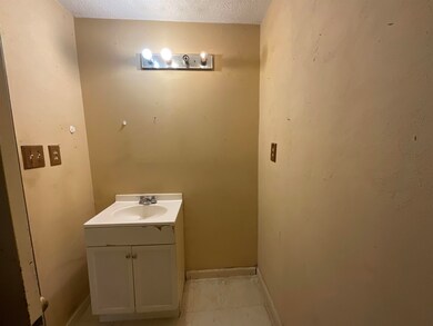 Bathroom with tile floors, a textured ceiling, and