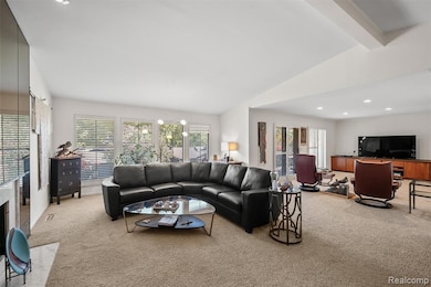 Living room featuring light colored carpet and recessed lighting