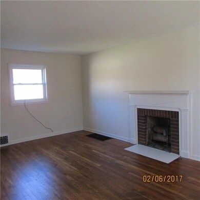 Living room with cozy decorative fireplace.