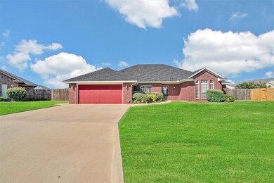 Ranch-style home featuring a garage and a front ya