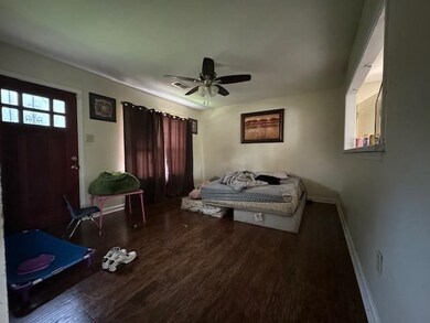 Living room with ceiling fan and dark hardwood / w