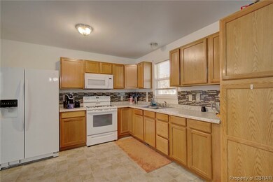 Kitchen featuring light tile flooring, tasteful ba