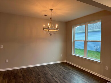 Spare room featuring a notable chandelier and dark