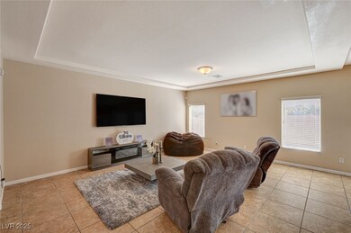 Living room with a raised ceiling, tile patterned