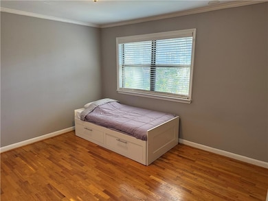 Secondary Bedroom with light wood-type flooring an