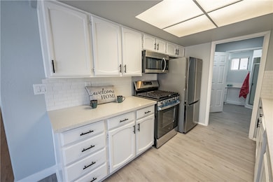 Kitchen featuring stainless steel appliances, ligh