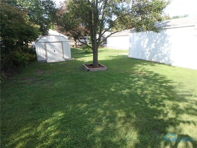 Fenced back yard with newer shed