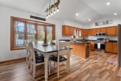 A family dining room with a view of the backyard and the kitchen creates a seamless, welcoming space that connects everyday living with the outdoors.