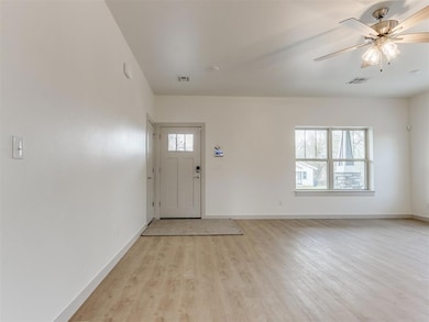 Entryway with baseboards, light wood-style floorin