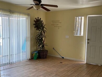 Foyer entrance with a ceiling fan, light wood fini