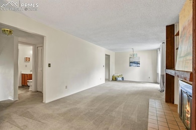 Unfurnished living room with a textured ceiling, s