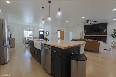 Kitchen with light wood-style flooring, a sink, st