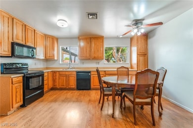 Kitchen featuring black appliances, healthy amount