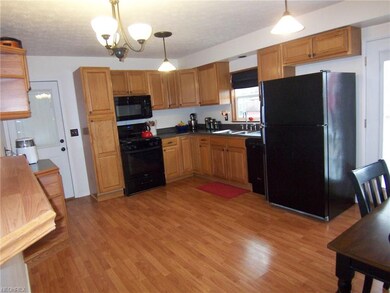 Large eat-in kitchen has new cabinets, laminate ap