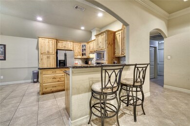 Kitchen featuring a peninsula, visible vents, arch