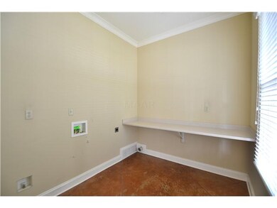 A light-filled laundry room is just to the right o