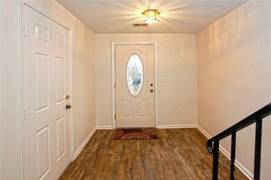 The spacious entry has a classy lead glass door to