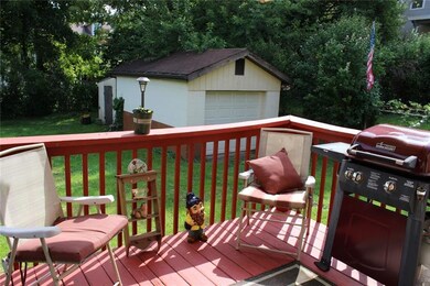 Deck overlooking level fenced backyard