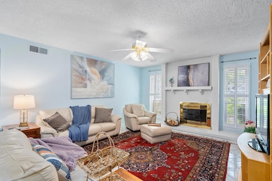 Living room with a textured ceiling, a healthy am