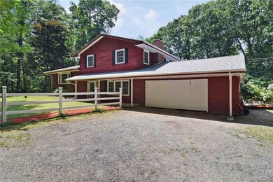 Set on a lush and wooded 5.6 acre lot