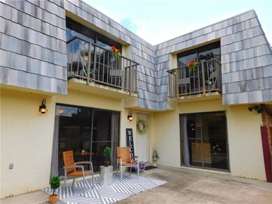 Great room and Kitchen have sliding glass doors to the patio and Bedrooms upstairs have balconies overlooking the patio.