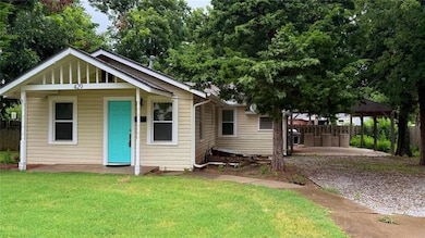 Bungalow featuring a patio, a carport, and gravel driveway