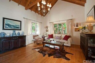 The spacious living room features tall beamed ceil