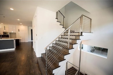 Stairs featuring recessed lighting and wood finished floors