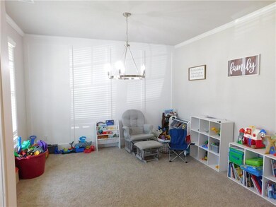 Recreation room with carpet floors, crown molding, and a chandelier