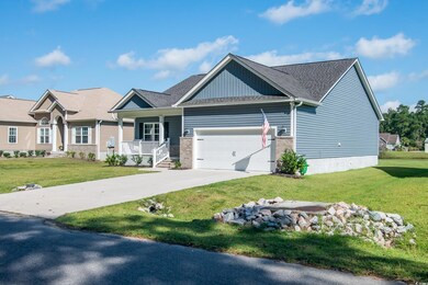 Craftsman-style house with a front yard, a garage,