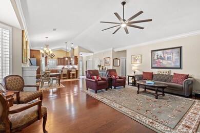 Living room featuring ceiling fan with notable cha