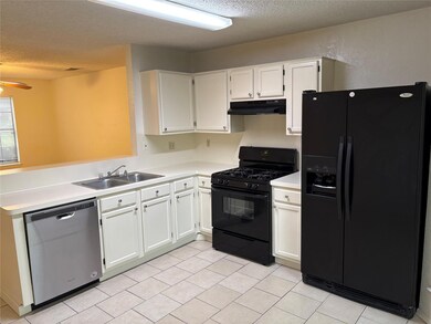 Kitchen featuring white cabinets, under cabinet r