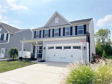 View of front of home with garage, a front lawn, p