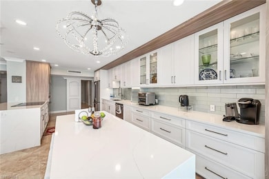 Kitchen with a sink, decorative backsplash, appliances with stainless steel finishes, visible vents, and recessed lighting