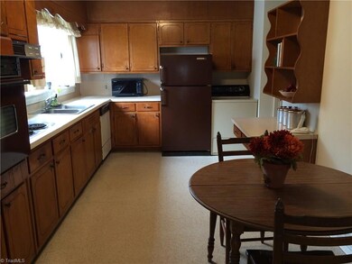 Kitchen with eating area, pantry to the right of washer, nice sunny window over sink