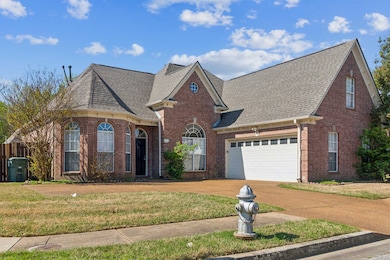 View of front of home featuring a shingled roof, c