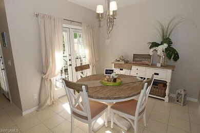 Tiled dining room featuring a chandelier and frenc