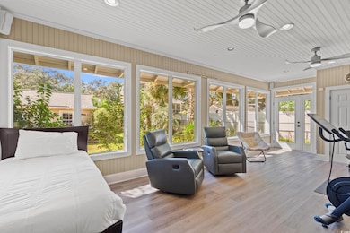 Bedroom featuring wood finished floors, access to outside, recessed lighting, and a wall mounted air conditioner