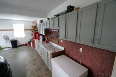 The car garage has been painted, cabinets added an