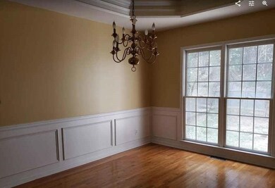 Living area featuring crown molding and wood finis