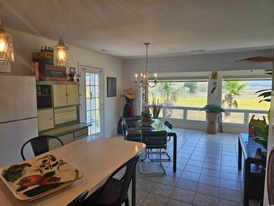 Tiled dining room with a notable chandelier and a 